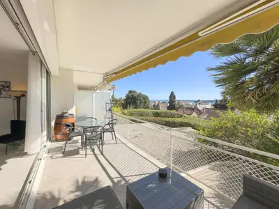 a patio with a table and chairs on a balcony at Le KamS in Cannes