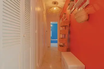 a hallway with red walls and a staircase with baskets at Le Val Joli by Winsome Destination in Cannes