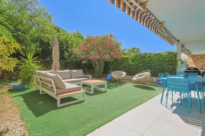 a patio with a couch and chairs and a table at Le Val Joli by Winsome Destination in Cannes