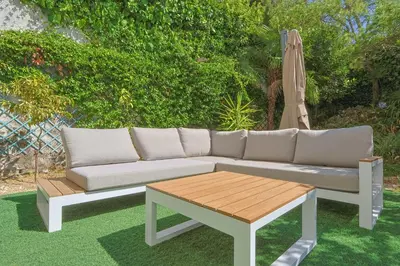 a couch and a table and an umbrella at Le Val Joli by Winsome Destination in Cannes