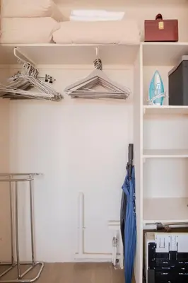 a room with two hangers and an umbrella at Cannes 2 pièces lumineux terrasse ensoleillée in Cannes