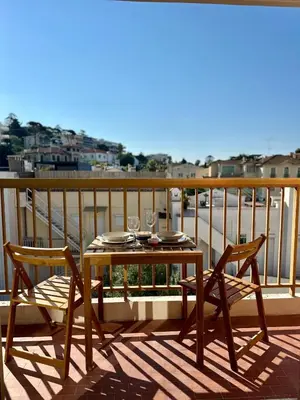a table and two chairs on a balcony with a view at Studio lumineux 5 minutes Croisette et rue Antibes in Cannes