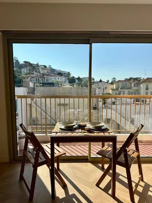 a table and chairs on a balcony with a view at Studio lumineux 5 minutes Croisette et rue Antibes in Cannes