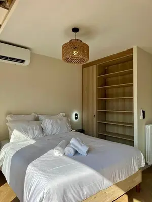 a bedroom with a large bed with towels on it at Studio lumineux 5 minutes Croisette et rue Antibes in Cannes