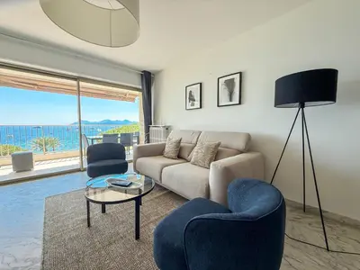a living room with a couch and two chairs at Sea View Apartment - Croisette in Cannes