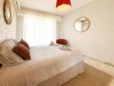 a bedroom with two beds and a mirror at Sea View Apartment - Croisette in Cannes