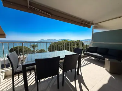 a bedroom with a large white bed with towels on it at Sea View Apartment - Croisette in Cannes