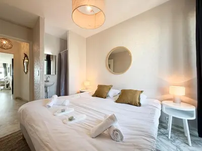 a bedroom with a large white bed with towels on it at Sea View Apartment - Croisette in Cannes