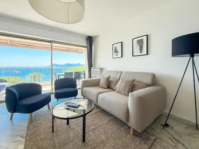 a balcony with a table and chairs and the ocean at Sea View Apartment - Croisette in Cannes