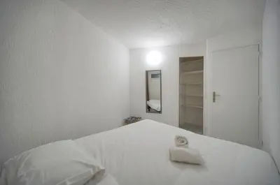 a white bedroom with a white bed with a towel on it at Charmant 2 pièces MEYNADIER-FORVILLE A1B269 in Cannes