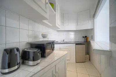 a kitchen with white cabinets and a toaster on a counter at Charmant 2 pièces MEYNADIER-FORVILLE A1B269 in Cannes