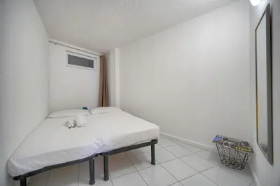 a small white room with a bed in it at Charmant 2 pièces MEYNADIER-FORVILLE A1B269 in Cannes
