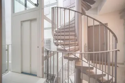 a spiral staircase in a room with a window at Charmant 2 pièces MEYNADIER-FORVILLE A1B269 in Cannes