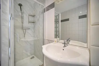 a white bathroom with a sink and a shower at Charmant 2 pièces MEYNADIER-FORVILLE A1B269 in Cannes