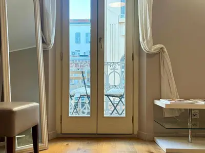 a room with a door with a view of a city at Cozy 1 Bedroom apartment hypercentre in Cannes