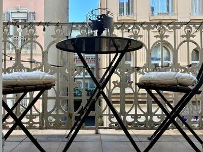 a glass table and two chairs on a balcony at Cozy 1 Bedroom apartment hypercentre in Cannes