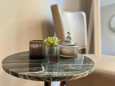 a glass table with a vase with a plant on it at Cozy 1 Bedroom apartment hypercentre in Cannes