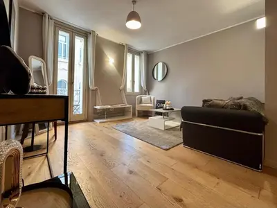 a living room with a couch and a table at Cozy 1 Bedroom apartment hypercentre in Cannes