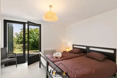 a bedroom with a large bed and a balcony at Villa Rose Pool Sea View Super Cannes in Vallauris