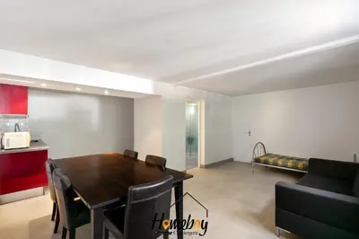 a living room with a table and a couch at Villa Rose Pool Sea View Super Cannes in Vallauris
