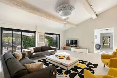 a living room with a couch and a table at Villa Rose Pool Sea View Super Cannes in Vallauris