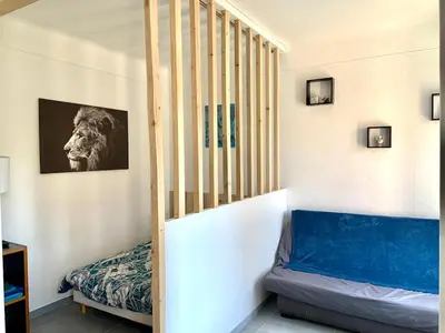 a room with a staircase with a lion picture on the wall at Appartement Le Central Park in Le Cannet
