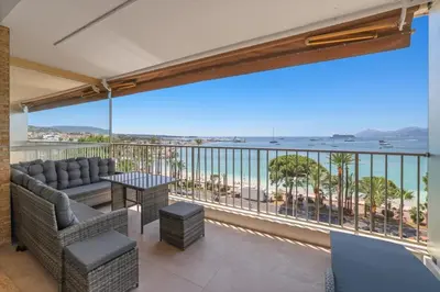 a balcony with a view of the ocean at REF 2006 - Cannes Croisette - Luxurious apartment with sea view for rent in Cannes