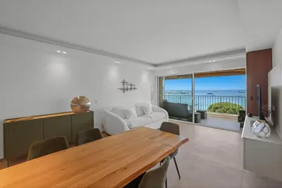 a living room with a table and a couch at REF 2006 - Cannes Croisette - Luxurious apartment with sea view for rent in Cannes