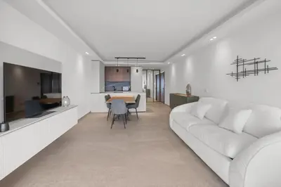 a living room with a white couch and a table at REF 2006 - Cannes Croisette - Luxurious apartment with sea view for rent in Cannes