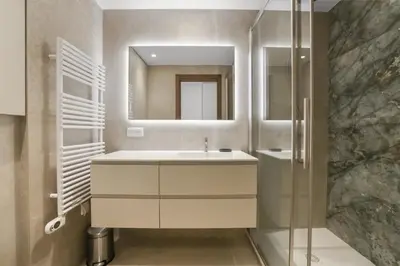 a bathroom with a sink and a mirror at REF 2006 - Cannes Croisette - Luxurious apartment with sea view for rent in Cannes