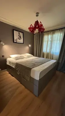 a bedroom with a large bed and a window at Renovated & cozy apartment in Cannes