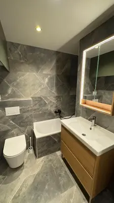 a bathroom with a sink and a tub and a toilet at Renovated & cozy apartment in Cannes