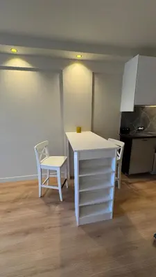 a kitchen with a white table and a white chair at Renovated & cozy apartment in Cannes