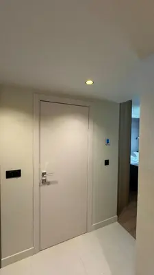 a white door in a room with a bedroom at Renovated & cozy apartment in Cannes