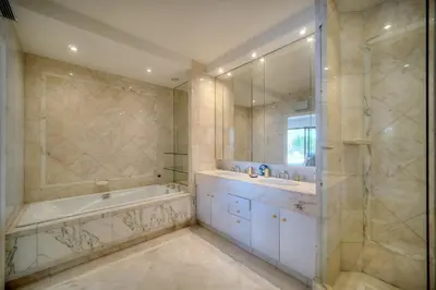 a bathroom with a tub and a sink and a shower at REF 1429 - Cannes Croisette - Sea view apartment for rent in Cannes