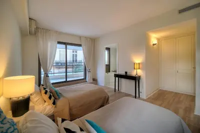 a large bedroom with two beds and a window at REF 1429 - Cannes Croisette - Sea view apartment for rent in Cannes