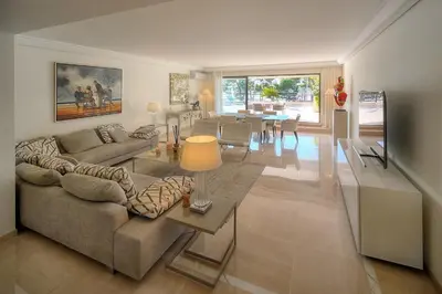 a living room with a couch and a table at REF 1429 - Cannes Croisette - Sea view apartment for rent in Cannes