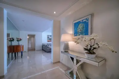 a living room with a table and a painting on the wall at REF 1429 - Cannes Croisette - Sea view apartment for rent in Cannes
