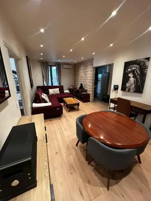 a living room with a table and a couch at Townhouse with garden in Cannes