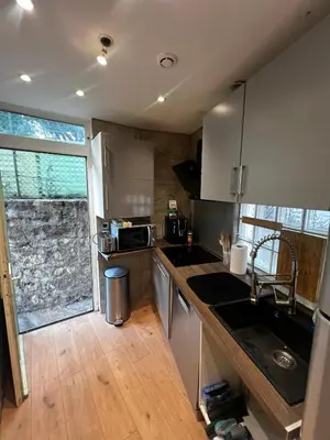 a kitchen with a sink and a counter top at Townhouse with garden in Cannes