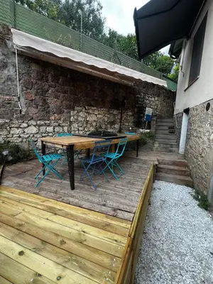 a wooden deck with a table and chairs on it at Townhouse with garden in Cannes