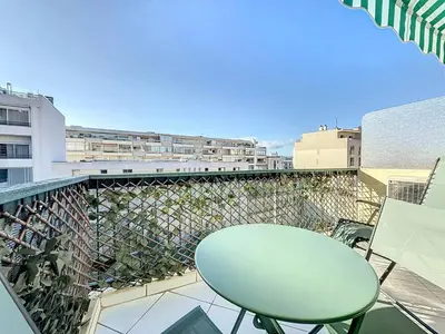 a balcony with a table and chairs on a building at INTUITION Studio avec terrasse 3min Croisette in Cannes