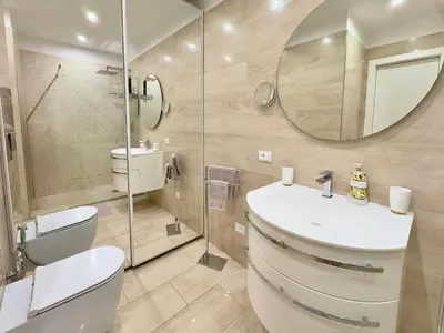 a bathroom with a toilet and a sink and a mirror at Le Kallisté By SCLS Locations in Cannes