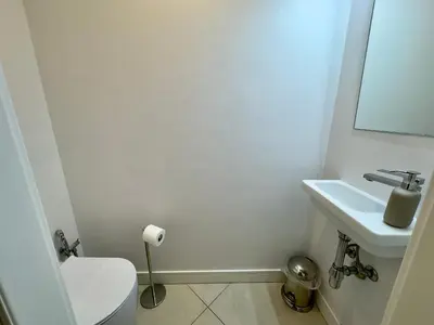 a bathroom with a white toilet and a sink at Le Kallisté By SCLS Locations in Cannes