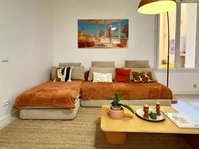 a bedroom with a bed and a couch and a table at Le Kallisté By SCLS Locations in Cannes