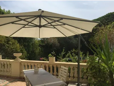 a table and an umbrella on a fence at 170 m2 with terrace near Croisette in Cannes