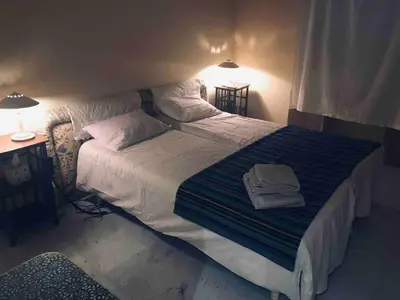 a bedroom with a large bed with a blue blanket at 170 m2 with terrace near Croisette in Cannes