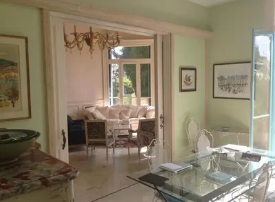 a living room with a couch and a glass table at 170 m2 with terrace near Croisette in Cannes