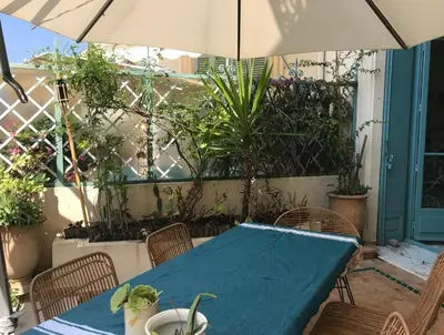 a blue table with chairs and an umbrella at 170 m2 with terrace near Croisette in Cannes