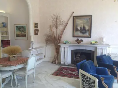 a living room with a table and a fireplace at 170 m2 with terrace near Croisette in Cannes